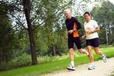 Senior Couple Running In The Woods