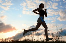 Silhouette woman run under blue sky with clouds